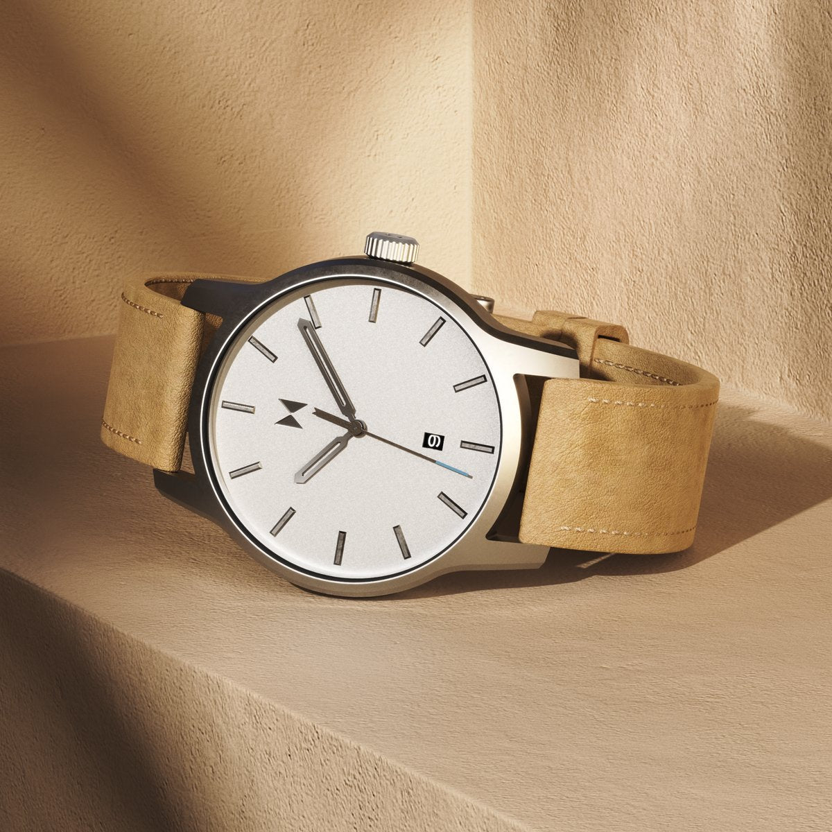 Classic II watch with brown suede strap and white dial laying on a brown ledge.