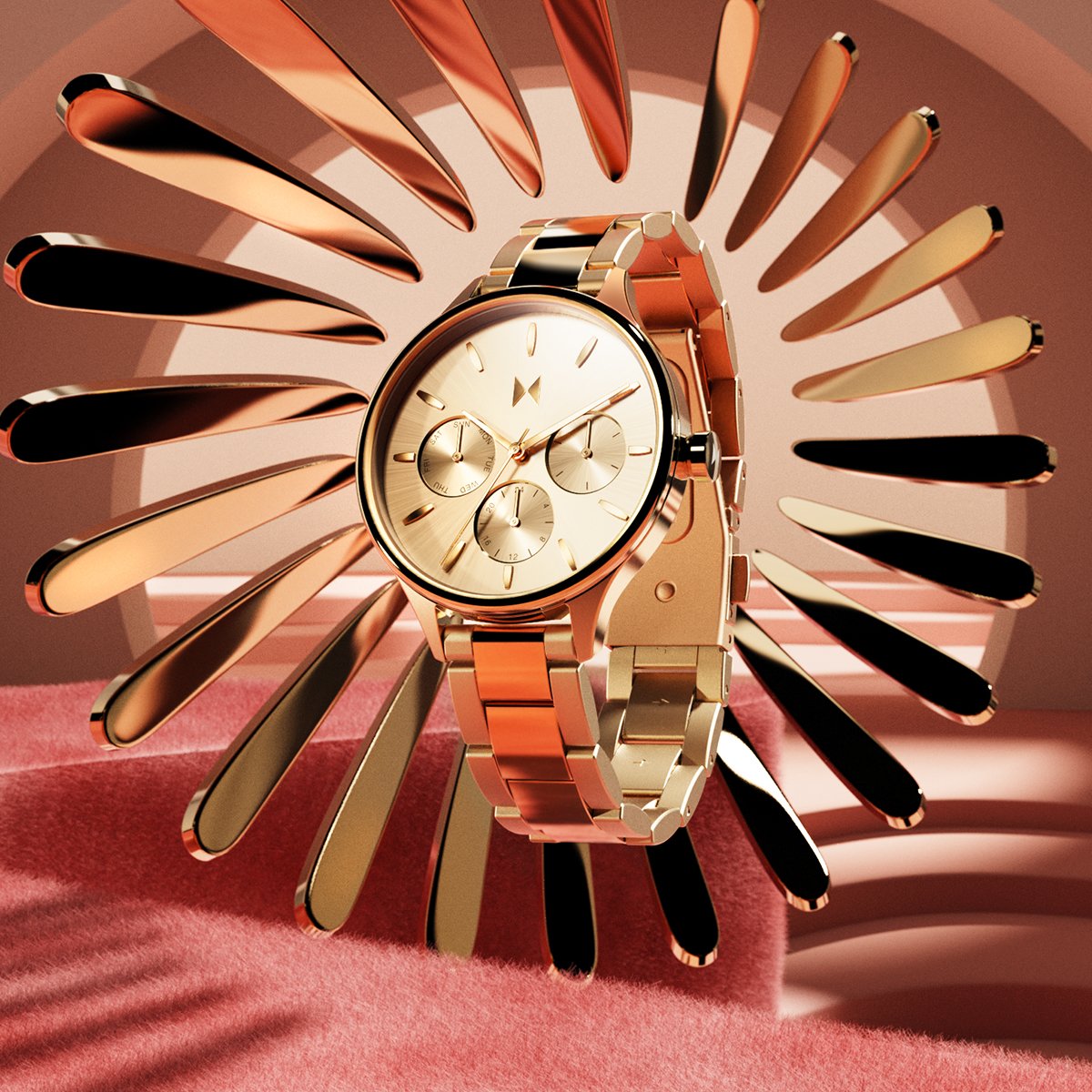 Rose-gold chronograph watch with a champagne dial and metal bracelet, displayed against a sculptural pink-and-gold backdrop.
