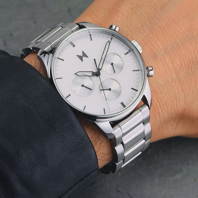 Man wearing the stainless steel Airhawk bracelet watch with white chronograph dial.